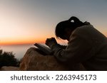 Small photo of Silhouette of woman kneeling down praying for worship God at sky background. Christians pray to jesus christ for calmness. In morning people got to a quiet place and prayed. copy space.