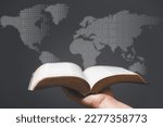 Small photo of Hand holding Holy Bible and world map in blur background. World mission christian idea. Copy space for text. Christian background for great commission or earth day concept.