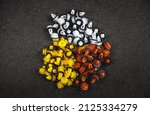 Small photo of Macro photography of plastic multi-colored clips for a car on a gray background. Car clips, plastic fasteners, multicolored plastic clips on a gray background close-up.Car clips and fasteners.