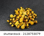 Small photo of Macro photography of plastic yellow clips for a car on a gray background. Car clips, plastic fasteners.Yellow plastic clips on a gray background close-up.Car clips and fasteners.