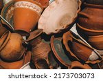 Small photo of Vintage, vintage clay pots are piled on top of each other. Collection of baked clay tableware. Ancient clay jugs close-up. The concept of collecting vintage retro items. Pottery.