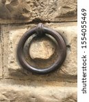 Small photo of Antique brass ring on building for horse tie off