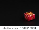 Christmass  tmass gift in red paper isolated at black background