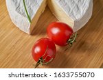 Cheese and tomatoes on wooden...