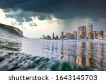 Tsunami king tide, dark stormy sky and rain approach the buildings of Surfers paradise, Gold Coast, Australia. Tsunami, King Tide or Cyclone concept