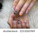 Beautiful woman Fingernails with pink color Gel Nail Art Design for Halloween Festival Painting Cobweb and shiny black Spider on Ringfinger, halloween nail art
