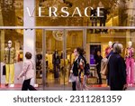 Small photo of Barcelona, Spain-April 29, 2023. Versace, Italian fashion house, based in Milan, Lombardy. Founded by Gianni Versace in 1978 and owned by Michael Kors. Logo on the front door