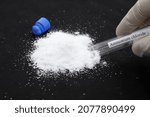 Small photo of ammonium chloride in test tube and black background