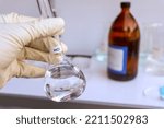 Small photo of hydrochloric acid in glass, chemical in the laboratory and industry, corrosive chemical