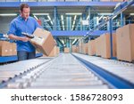 Worker Using Scanner In Warehouse Despatch Area