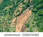 drone shot aerial view top angle bright sunny day cloudy mountainous terrain hills area agricultural region rocks wallpaper background india tamilnadu tourism natural scenery afforestation forest