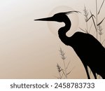 silhouette of a heron next to...
