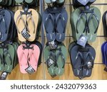 Small photo of Yogyakarta, Indonesia - January 15, 2024: Various rubber flip flops hanging on display at an footwear store. Vibrant summer flip flop sandals.