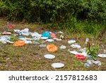 Rubbish, trash left after picnic. People illegally throw garbage into the forest. Illegal garbage dump in the nature.