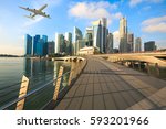 Travel, Transportation concept - Airplane flying over Singapore city in morning time