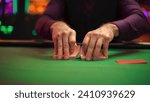 Small photo of Close Up On Hands Of Professional Poker Dealer Doing A Riffle Shuffle Of Playing Cards Before High Stakes Game In Luxurious Casino. Anonymous Croupier Shuffling Deck Before Poker Tournament.