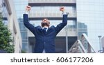 Small photo of A businessman dancing in the square and is glad to have received a promotion or winning a bet. Concept: finance, business, elation, victory, wager, career, dance