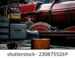 Small photo of Platform with luggage on the background of Hogwarts Express in the amusement park Universal Studios Hollywood The Wizarding World of Harry Potter December 9, 2022