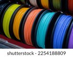 Small photo of Many multi-colored spools of thread of filament for printing 3d printer. Material coils for printing 3D printer. Spools of 3D printing motley different colors filament. ABS wire plastic for 3d printer