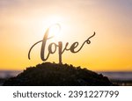 Small photo of Black outlines of word Love at dawn and sunset on sky on seashore. Stick contours in shape word Love in sand on backdrop of setting and rising sun on seashore. Concept Love infatuation Valentine's Day