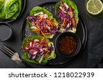 rainbow vegetarian lettuce wraps  on black plate, top view