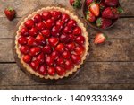 delicious strawberry tart on wooden background, top view, copy space