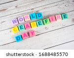 Small photo of "World cease fire day "-the words on wooden cubes. A background image of english words on colorful building blocks.