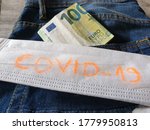 Small photo of one hundred euros in a trouser pocket and a protective face mask, the concept of how much it will cost to protect oneself from a man 19