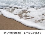 Sea Foam On Beach Sand  With...