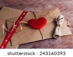 Valentine's day.Envelope with  red hearts on Brown wooden background.