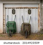 Two Old Wheelbarrows Stand...
