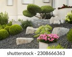 Modern front garden with bushes and flowers and rocks