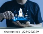 Small photo of Businessman using smartphone showing rocket and icon Startup business concept Entrepreneurship concept and online digital business network connection on the interface Online Marketing, Technology and