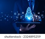 Small photo of The hand shows a rocket. Concept of Startup Business, Entrepreneurship Idea, and Online Digital Business. network connection on the interface Marketing, Technology, and Success