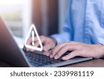 Small photo of Businessman using laptop showing warning triangle and exclamation sign icon Warning of dangerous problems Server error. Virus. Maintenance concept. caution internet technology network security