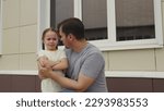 Small photo of little girl makes scandal her dad. Upset Child throws temper tantrum father. happy family. emotional stress Child outdoors. Child cries throws tantrum his father. crying kid. little daughter parent .