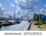 Small photo of River Thames view from Waterside Gardens, Wapping, St Katharine's, London with the Tower Bridge and the Shard building in the distance.