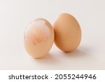 Small photo of peeled egg shell expose the egg membrane on white background.