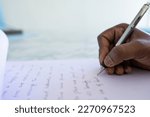 Small photo of Concept related to writing your story day, poetry day A person writing something on a table with a pen in white background Selective focus