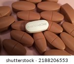 Small photo of Amiodarone white tablett pill of antiarrhythmic medication used to treat cardiac dysrhythmias including ventricular tachycardia, ventricular fibrillation and atrial fibrillation