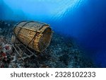 Small photo of Fish trap on the seabed underwater. Fish trap underwater. Underwater fish trap. Underwater coral fish trap