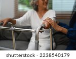 Healthcare worker or caregiver holding hands with a senior woman. Elderly healthcare and Home health care service concept