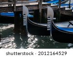 Small photo of Venice: gondolas with foreground of the oarlock moored on the grand canal