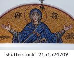 Small photo of Athens , Greece - 23.10. 2021 : Colourful mosaic hagiography of Mother of God ,on the facade above the entrance of the church of the Holy Apostles Peter and Paul in Pefki area in Athens