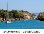 Small photo of Isthmia, Corinthia, Peloponnese, Greece - 18 of August 2022 : Boats passing Corinth Canal, with the bridge on top connecting mainland Greece with Peloponnese. Sunny day