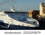 Small photo of Livorno, Italy - 07 31 2022: View on bow or forward part of Passenger Ro-Ro ship with blue hull and white top operated by the Italian company Grimaldi Lines proceeding astern to berth position.