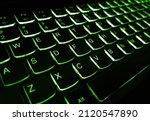Small photo of Laptop keyboard is glowing in the dark. Bright multicolor macro background flickering video button black laptop keyboard technology flicker. Technology is a Sophisticated World