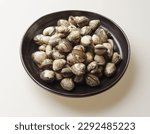 Small photo of Close-up of stacked raw cockles on black jar, South Korea