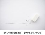 Small photo of Flat lay of white eraser delete black line pencil on white paper background copy space. Repair, remove, creative idea, imagination and education concept.