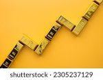 Small photo of Gold bars as graph chart growing up on yellow background copy space. Gold price increase rising in commodity trading bull market investment concept. Gold is store of value in recession crisis.